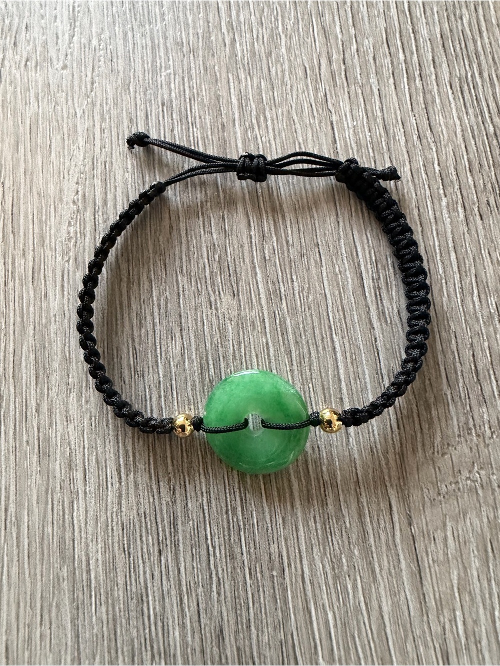 Adjustable Black Cord Bracelet with Green Jade Disc and Gold Accents